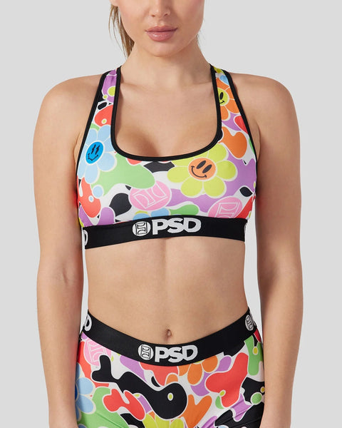 Colorful sports bra with multicolored daisy and smiley face print, black trim, and PSD waistband.