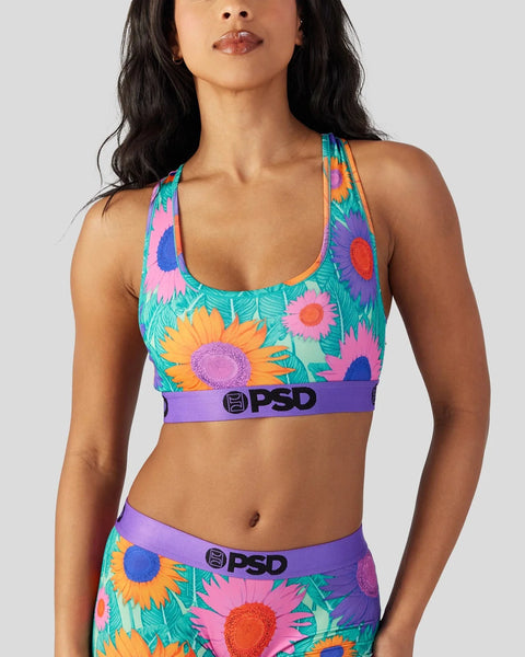 Colorful sports bra with multicolored sunflower print, purple PSD waistband, and racerback straps.