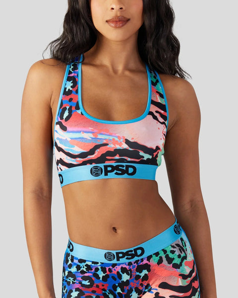 Sports bra with multicolored abstract animal print pattern, blue trim, and PSD logo waistband.