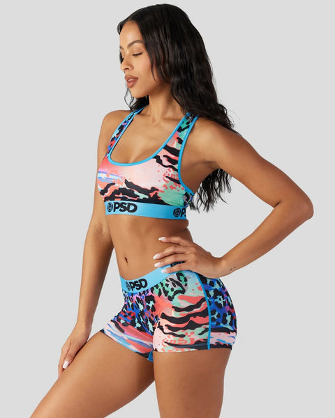 Women's sports bra and shorts set with multicolor abstract animal print and blue trim.