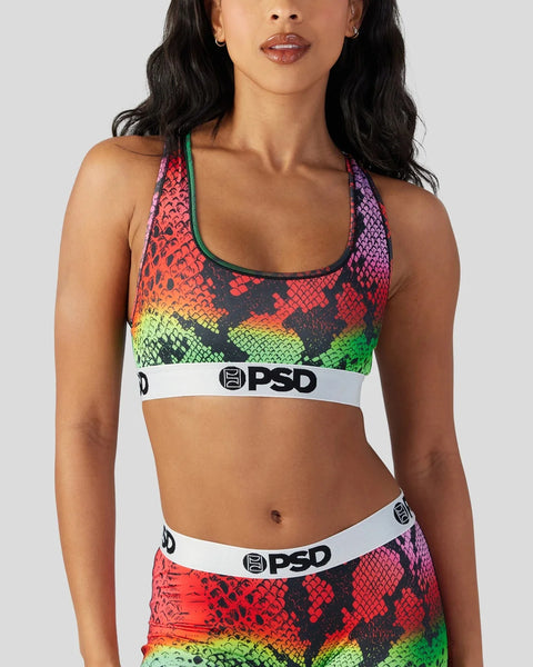 Multicolored snake scale print sports bra with white PSD waistband and green trim.