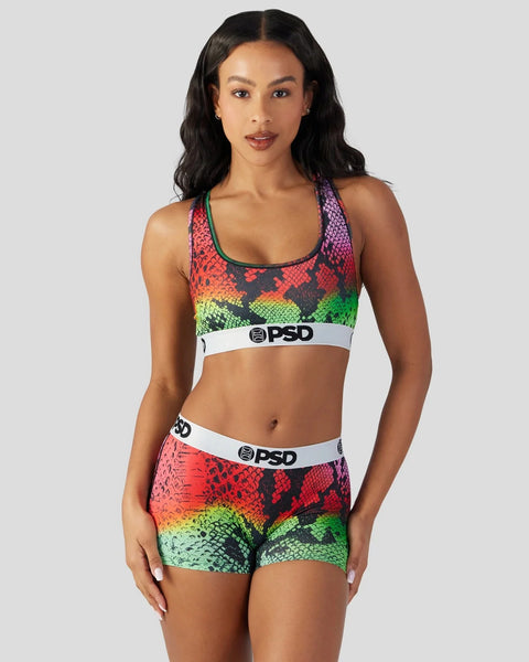 Colorful snake-pattern sports bra and shorts set with red, yellow, and green gradient scales and white PSD branding bands.