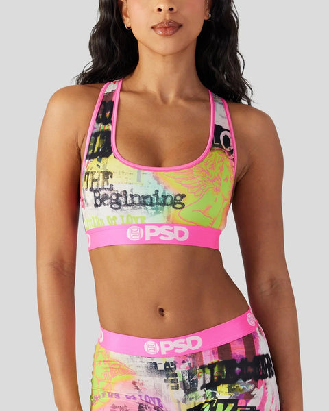 Woman wearing neon pink and yellow sports bra with graphic print and PSD waistband.