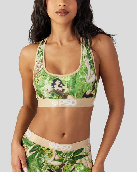Sports bra with green leaf and portrait print, featuring cream-colored PSD branding on elastic band.