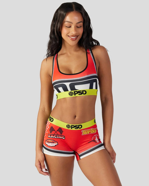 Red and white sports bra with black trim and neon yellow waistband featuring racing graphics and PSD branding.