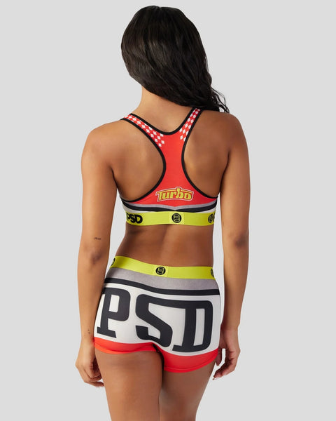 Red and neon yellow two-piece athletic set with geometric pattern straps and contrasting band details, shown from back view.