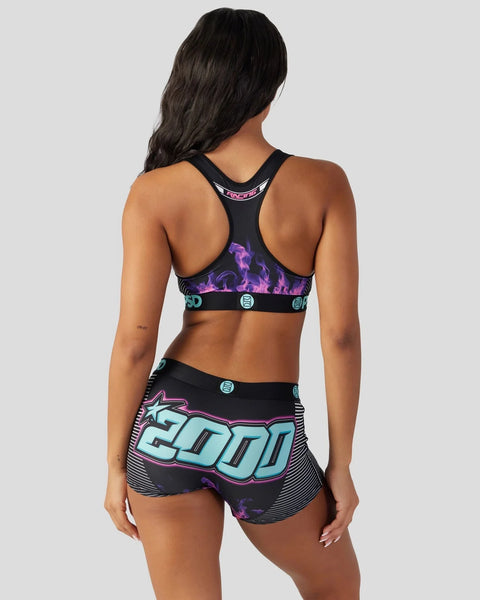 Black sports bra and shorts set with purple flame and turquoise graphic print design, shown from back view.