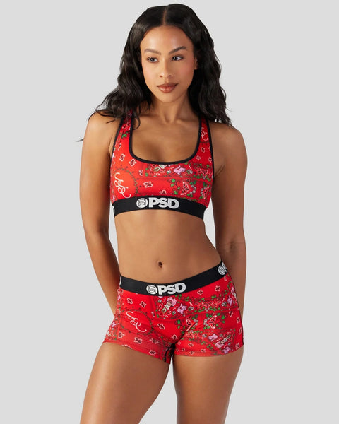 Red sports bra and shorts set with strawberry and floral print, black PSD waistband.