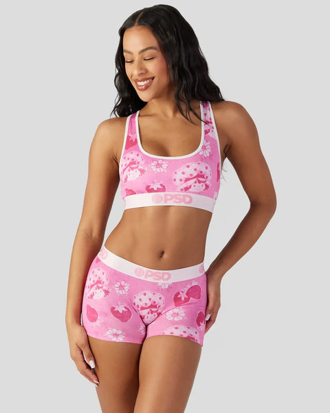 Pink velour sports bra and shorts set with strawberry and floral print, white trim and branding.