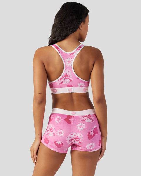 Pink velour sports bra and shorts set with strawberry and floral print, white trim details.