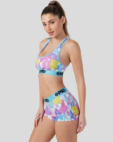 Sports bra and shorts set with colorful neon character print and blue trim bands.