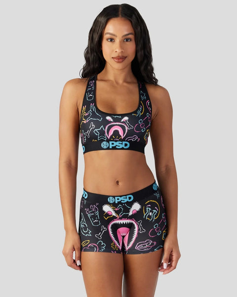 Black sports bra and shorts set with colorful neon monster face and graphic print design.