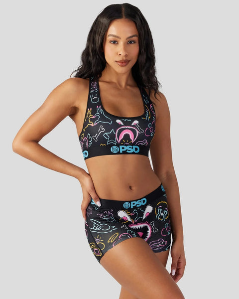 Black sports bra and shorts set with colorful neon doodle print and PSD branding.