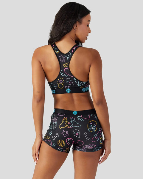 Black sports bra and shorts set with colorful neon line-drawn celestial and geometric patterns throughout.