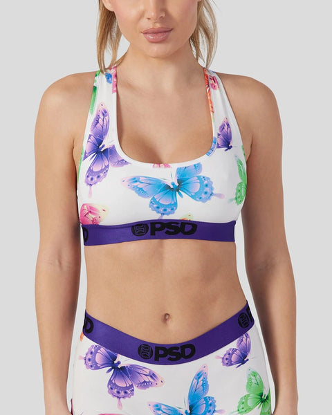 White sports bra with colorful butterfly print and purple PSD waistband.