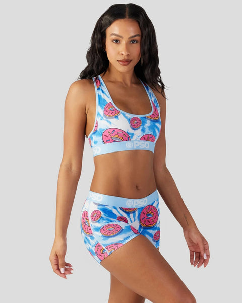 Women's two-piece athletic set with blue tie-dye and pink donut print on sports bra and shorts.