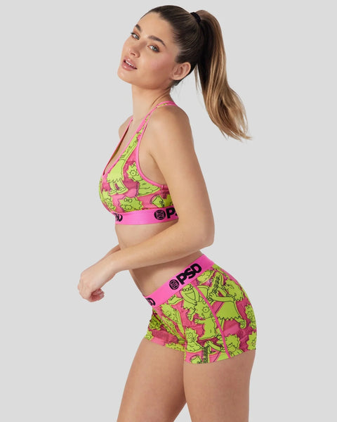Woman wearing pink and lime green Simpsons-themed sports bra and shorts set with character print.