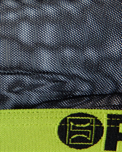 Black mesh fabric with perforated dot pattern and neon yellow binding at bottom edge with logo detail.
