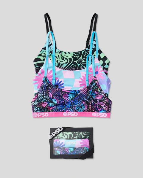 Three sports bras with cyan straps featuring abstract patterns including butterflies, flowers, and geometric designs, display