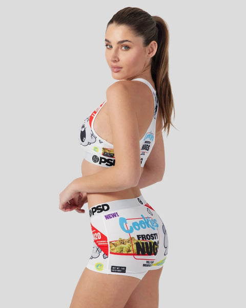 Woman wearing white sports bra and shorts with colorful cereal box graphic print.