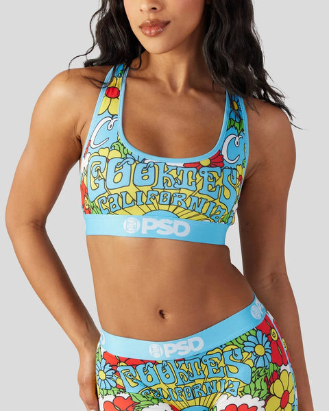 Woman wearing a blue and multicolored floral sports bra with 