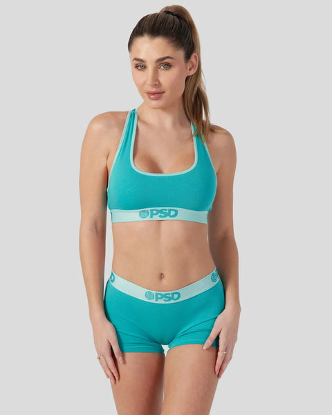Jade green racerback sports bra and matching boy shorts with light blue trim and PSD branding.