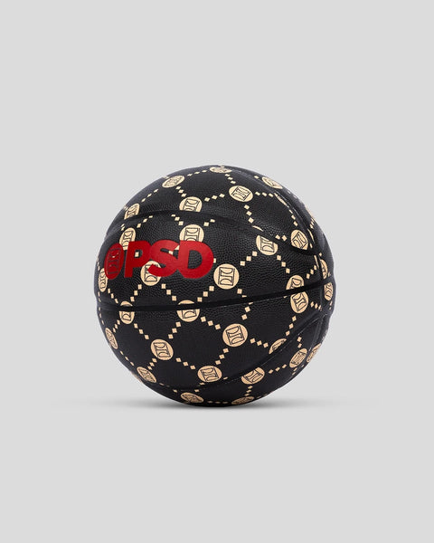 Black basketball with gold geometric emblem pattern and red branding across the center panel.