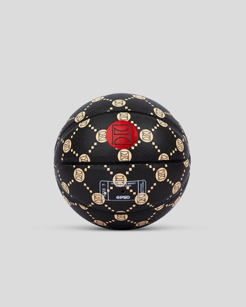 Black basketball with gold square emblems arranged in a circular pattern and a red circular emblem at the center.