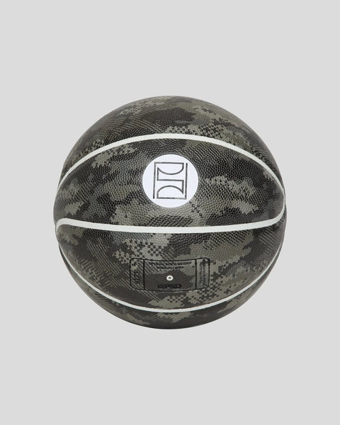 Basketball with dark camouflage pattern, white stripes, and circular logo panel on center.