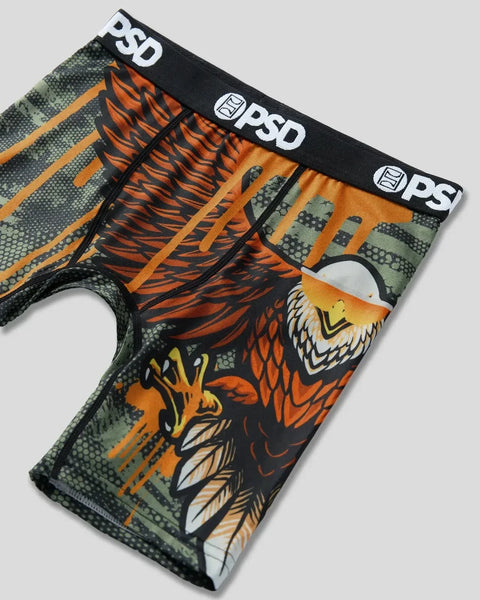 PSD brand underwear with black elastic waistband featuring eagle head graphic, orange tiger stripes, and green camouflage pat