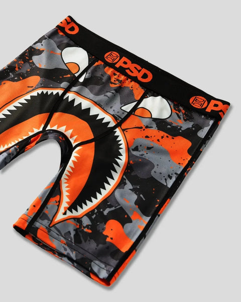 Black and orange fabric with shark mouth graphic design, white teeth, and splatter pattern details.
