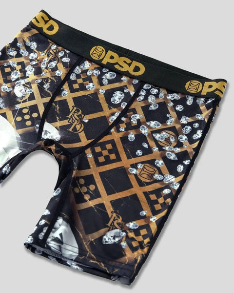 Black briefs with gold geometric grid pattern, diamond shapes, and PSD branding on waistband.