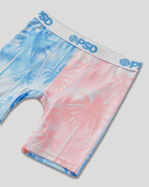 Two pairs of briefs with palm tree prints in blue and pink, featuring PSD brand waistbands.