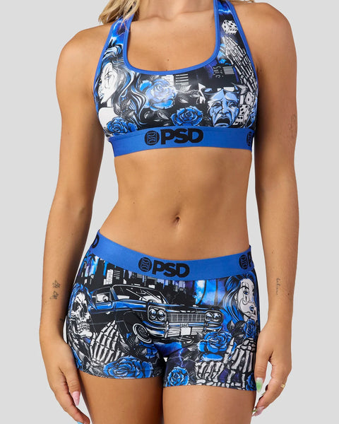 PSD sports bra and shorts set with blue, black, and white lowrider car and skull graphic print.