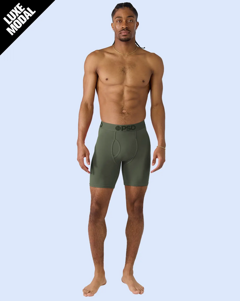 Man wearing forest green modal boxer briefs with PSD waistband.