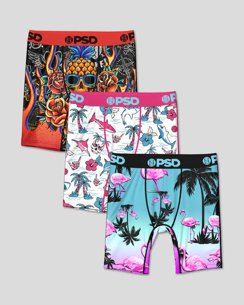 Three boxer briefs with tropical prints: black with skull and pineapple design, white with palm trees and fish, turquoise and