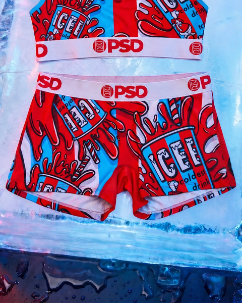 PSD red and blue ICEE boxer shorts with matching waistband, displayed flat on icy blue background.