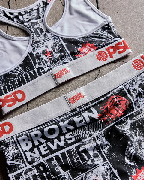 White sports bras with black and red graphic prints featuring skulls and text bands reading 