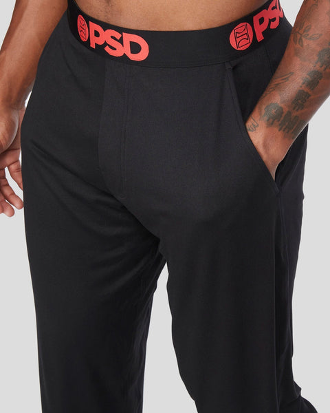 Black lounge pants with red PSD waistband and side pockets.
