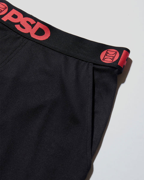 Black lounge pant with red branded waistband and logo detail on elastic cuff.