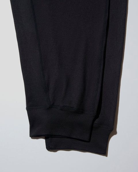 Black lounge pant with ribbed side seams and elastic cuffs at ankles.