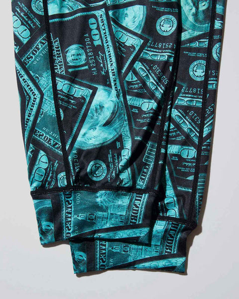 Turquoise and black lounge pants with all-over currency and circular seal print pattern.