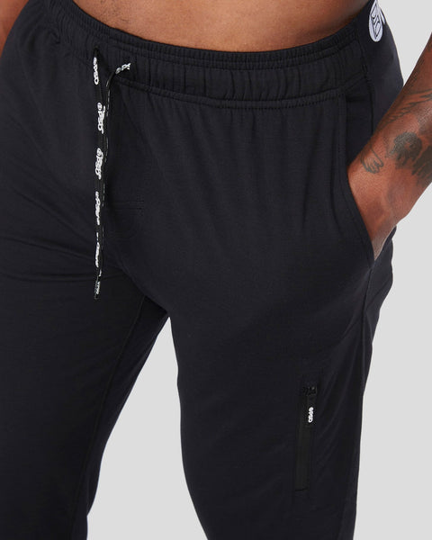 Black jogger with elastic waistband, drawstring, and side pockets shown on model.