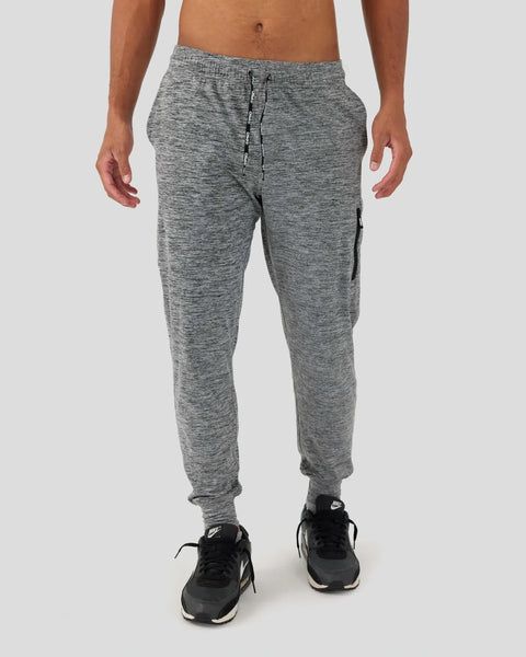 Grey heathered joggers with drawstring waist and side pocket, tapered ankles, worn with black athletic shoes.