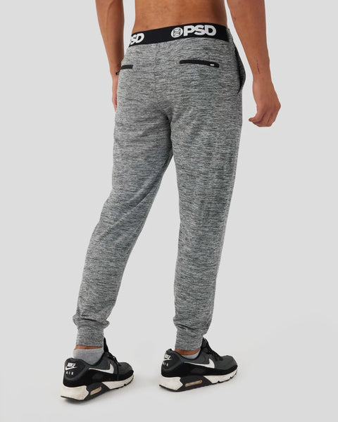Grey heathered joggers with black PSD waistband and back zip pockets, cuffed ankles.