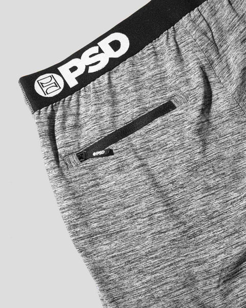 Grey heathered jogger pants with black elasticated waistband and brand logo label visible at waist.