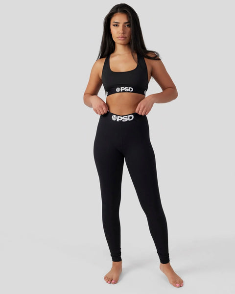 Black racerback sports bra and matching high-waist leggings with PSD branding.