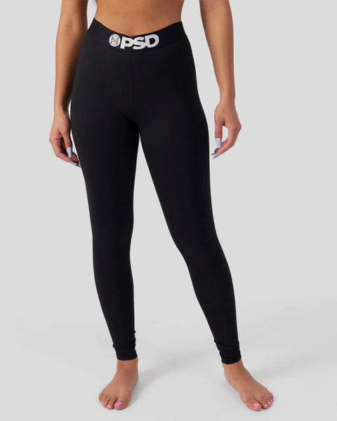 Black leggings with PSD branded waistband worn by model against white background.