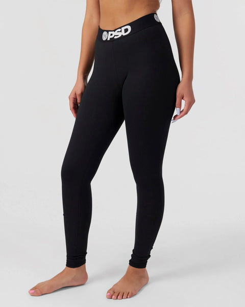 Black leggings with white PSD waistband, shown on model from waist to feet.