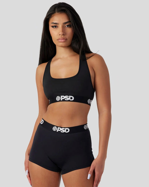 Black sports bra and shorts set with PSD branding on elastic waistbands.